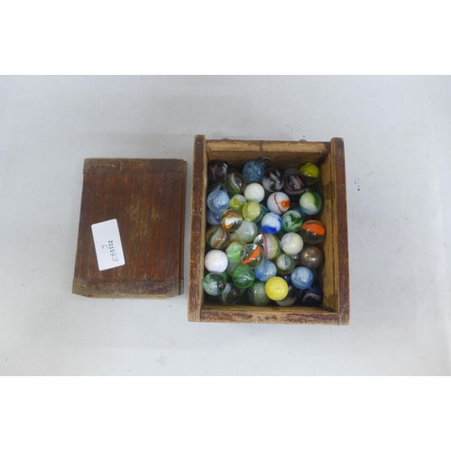 649 - A collection of marbles in a wooden box