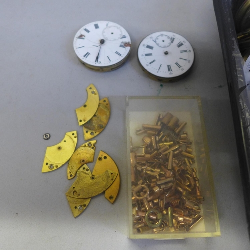 729 - A box of pocket watch movements, including English lever and a box of watch strap ends for lady's wa... 