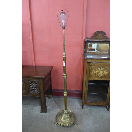 10 - An Arts and Crafts brass telescopic floor standing lamp