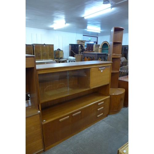 102 - A teak wall unit, a teak corner cabinet and a drop-leaf table