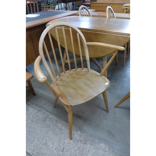 106 - An Ercol Blonde elm and beech drop-leaf table and four chairs