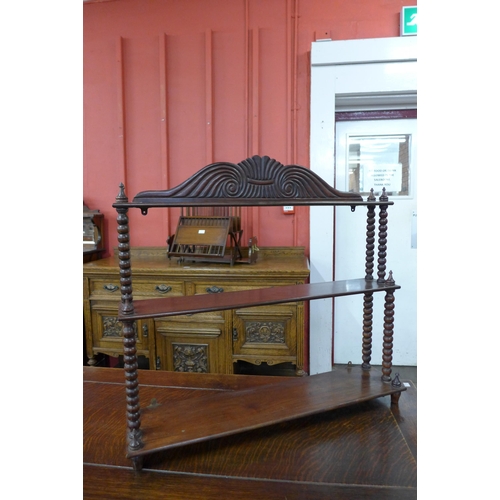 115 - A George IV mahogany three tier wall hanging shelf