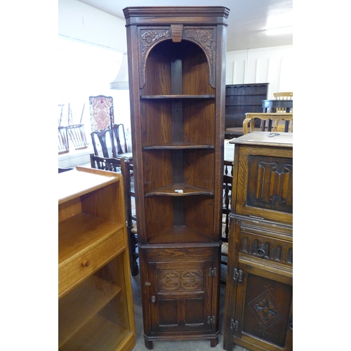 118 - A carved Ipswich oak floor standing corner cabinet