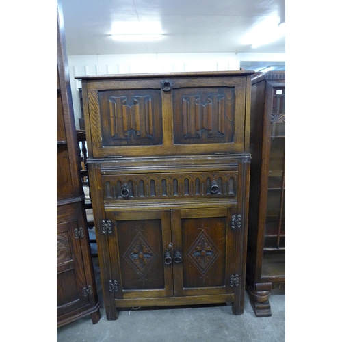 119 - A carved oak cocktail cabinet