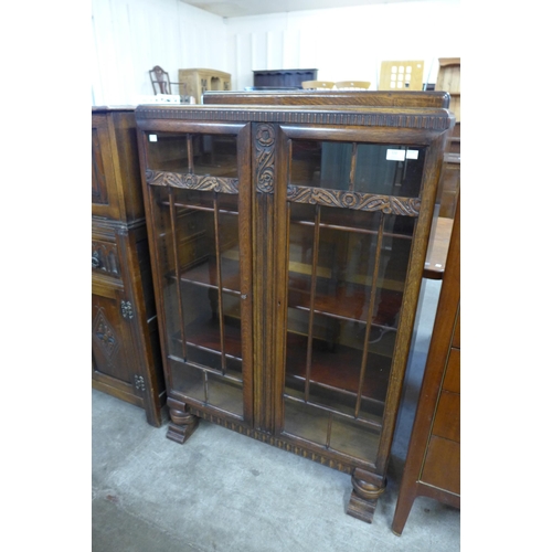 120 - A carved oak two door bookcase