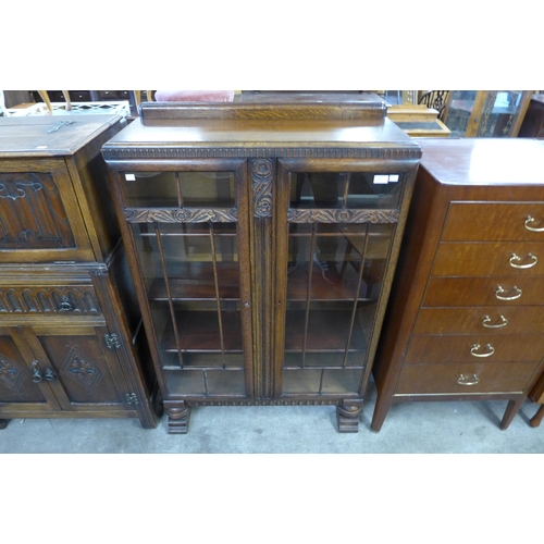 120 - A carved oak two door bookcase