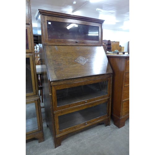 122 - An oak bureau bookcase