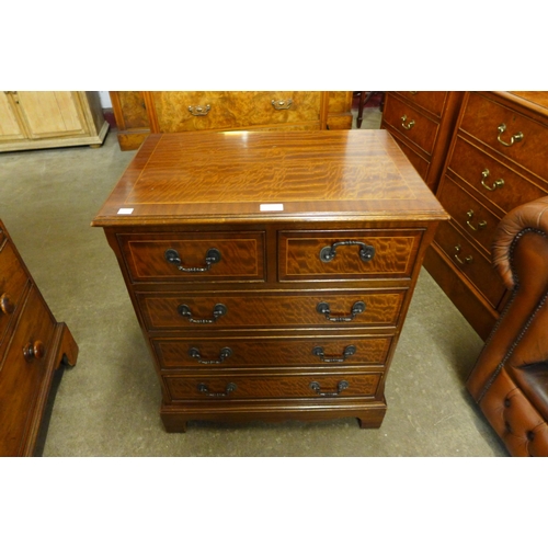 136 - An inlaid mahogany chest of drawers