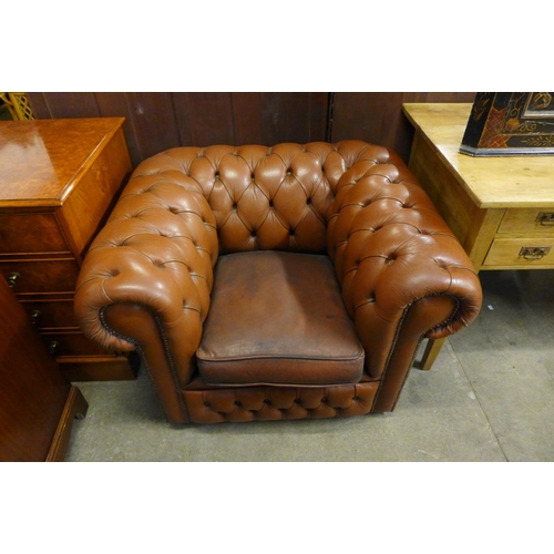 139 - A brown leather Chesterfield club chair