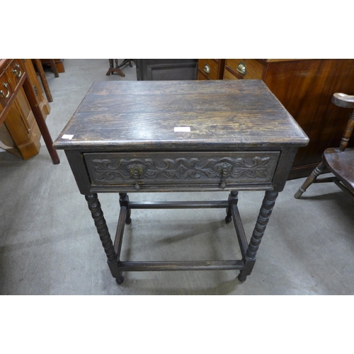 144 - A 17th Century style carved oak single drawer side table