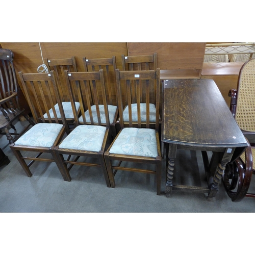 150 - An oak barleytwist gateleg table and six chairs