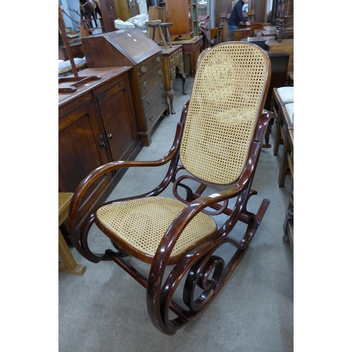 152 - A beech bentwood and rattan rocking chair