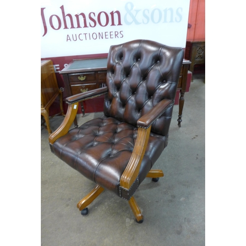 16 - A mahogany and chestnut brown leather revolving chair