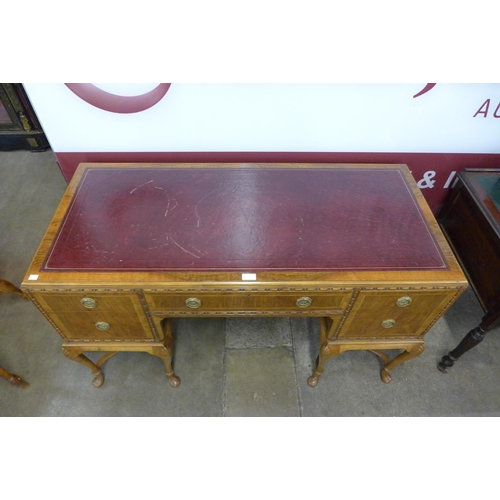 17 - A George I style inlaid walnut and red leather topped writing table