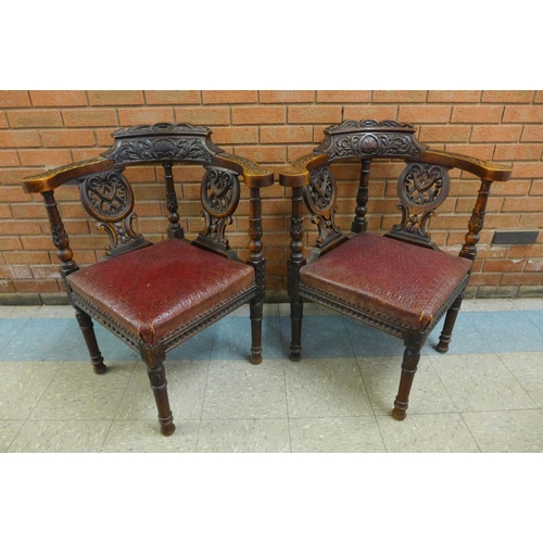 2 - A pair of Victorian Jacobean Revival carved oak corner chairs