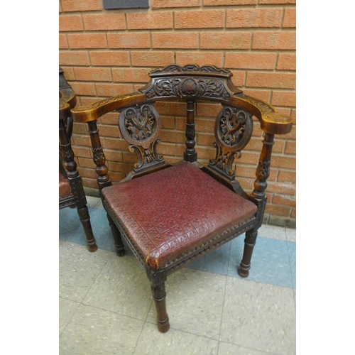 2 - A pair of Victorian Jacobean Revival carved oak corner chairs