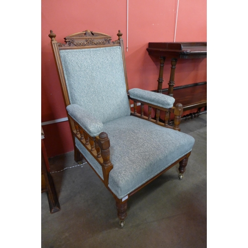 21 - A Victorian carved oak and fabric upholstered armchair