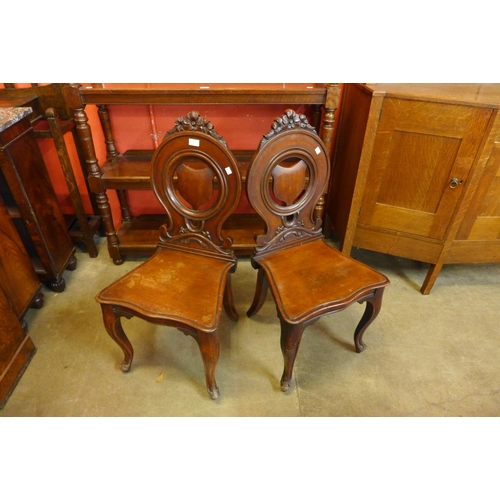 22 - A pair of Victorian mahogany hall chairs