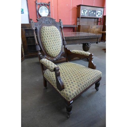 23 - A Victorian carved walnut and fabric upholstered armchair