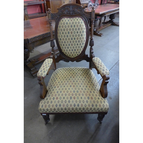 23 - A Victorian carved walnut and fabric upholstered armchair