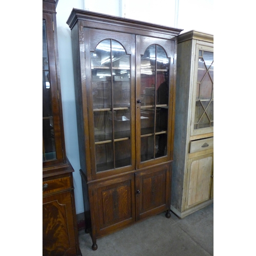 34 - An early 20th Century oak four door bookcase