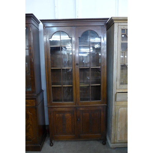 34 - An early 20th Century oak four door bookcase