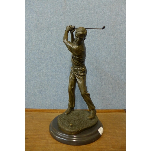 354 - A bronze figure of a golfer, on black marble socle