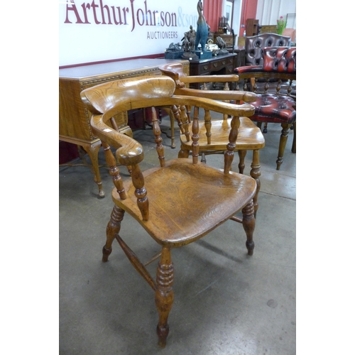 36 - A pair of similar Victorian elm and beech smokers bow chairs