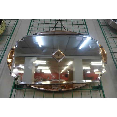 369 - An Art Deco peach bevelled mirror