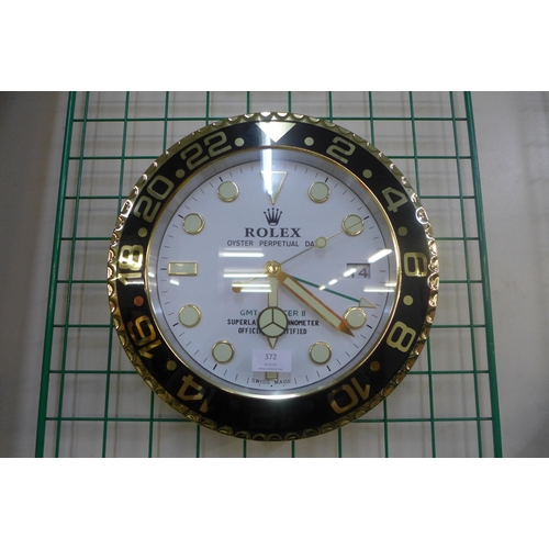 372 - A Rolex style dealer's circular wall clock