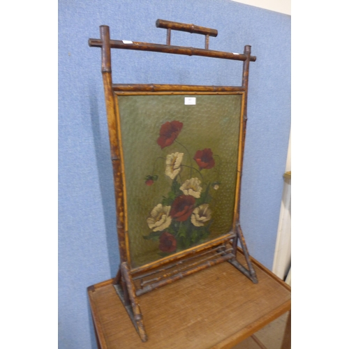 387 - A Victorian Aesthetic Movement painted glass and bamboo fire screen