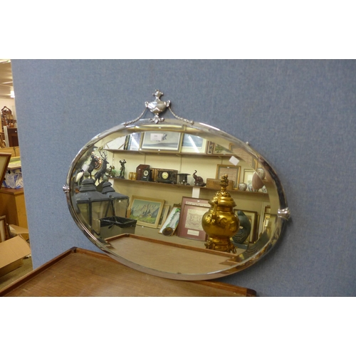 396 - An Art Deco steel framed oval mirror