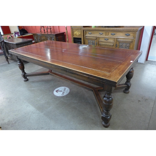 4 - A 17th Century style oak extending refectory table, 75cms h, 228cms l (348cms l extended), 106cms w