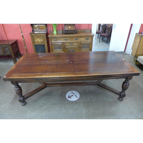 4 - A 17th Century style oak extending refectory table, 75cms h, 228cms l (348cms l extended), 106cms w