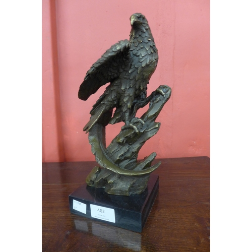 402 - A bronze figure of an eagle, on black marble socle