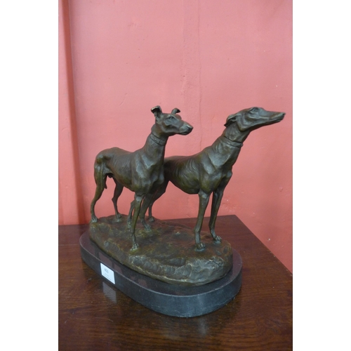 403 - A French style bronze figure of two greyhounds, on black marble plinth