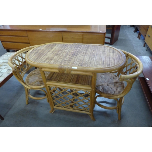 56 - A bamboo and rattan table and two chairs