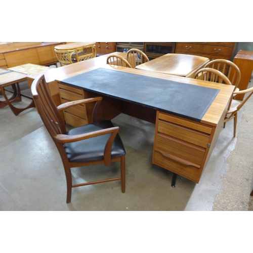 59 - A teak and black vinyl topped desk and chair