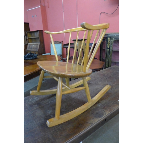 66 - An Ercol Blonde elm and beech 452 model cowhorn rocking chair