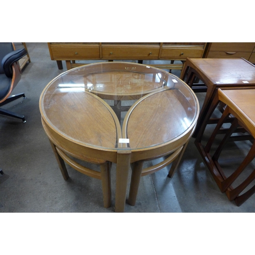 67 - A Nathan teak and glass topped circular nest of tables