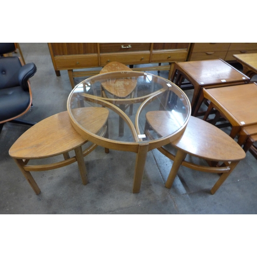 67 - A Nathan teak and glass topped circular nest of tables