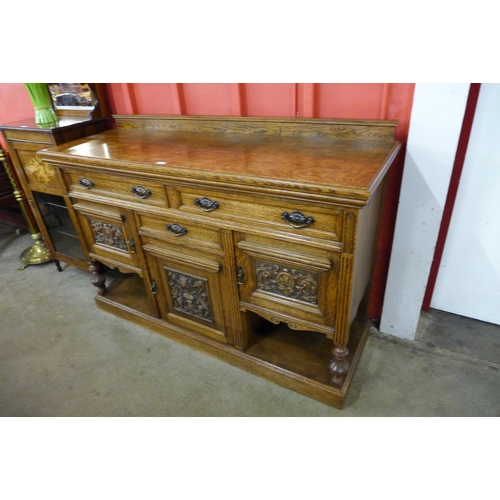 7 - A Victorian carved oak sideboard