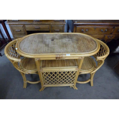 86 - A bamboo and rattan table and two chairs