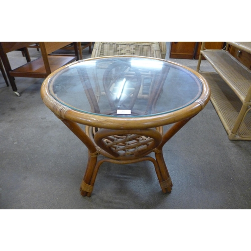 97 - A bamboo and glass topped circular coffee table