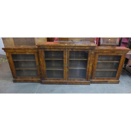 31 - A Victorian walnut four door breakfront bookcase, 103cms h, 298cms w, 38cms d