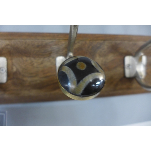 1312 - A rack of four coat hooks with ceramic knobs (HH563916)   #