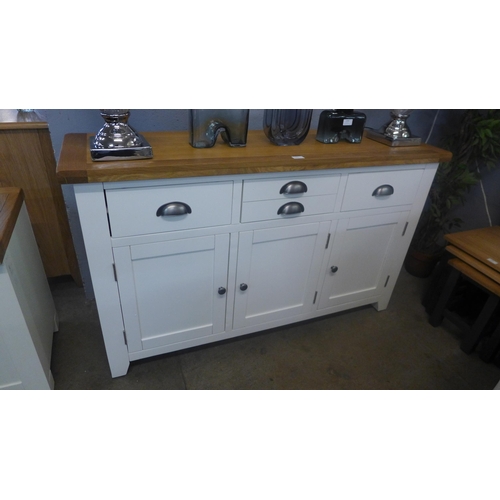 1316 - A white painted and oak three door sideboard * This lot is subject to VAT