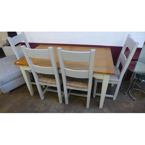 1500 - An oak and white painted extending dining table with a set of six ladderback dining chairs (marked)