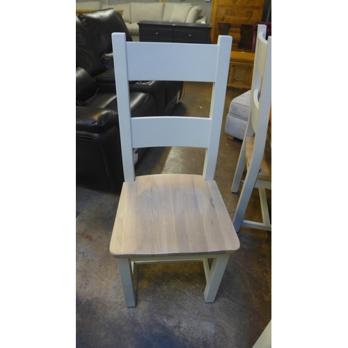 1500 - An oak and white painted extending dining table with a set of six ladderback dining chairs (marked)