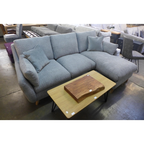 1508 - A light grey fabric three seater sofa/chaise